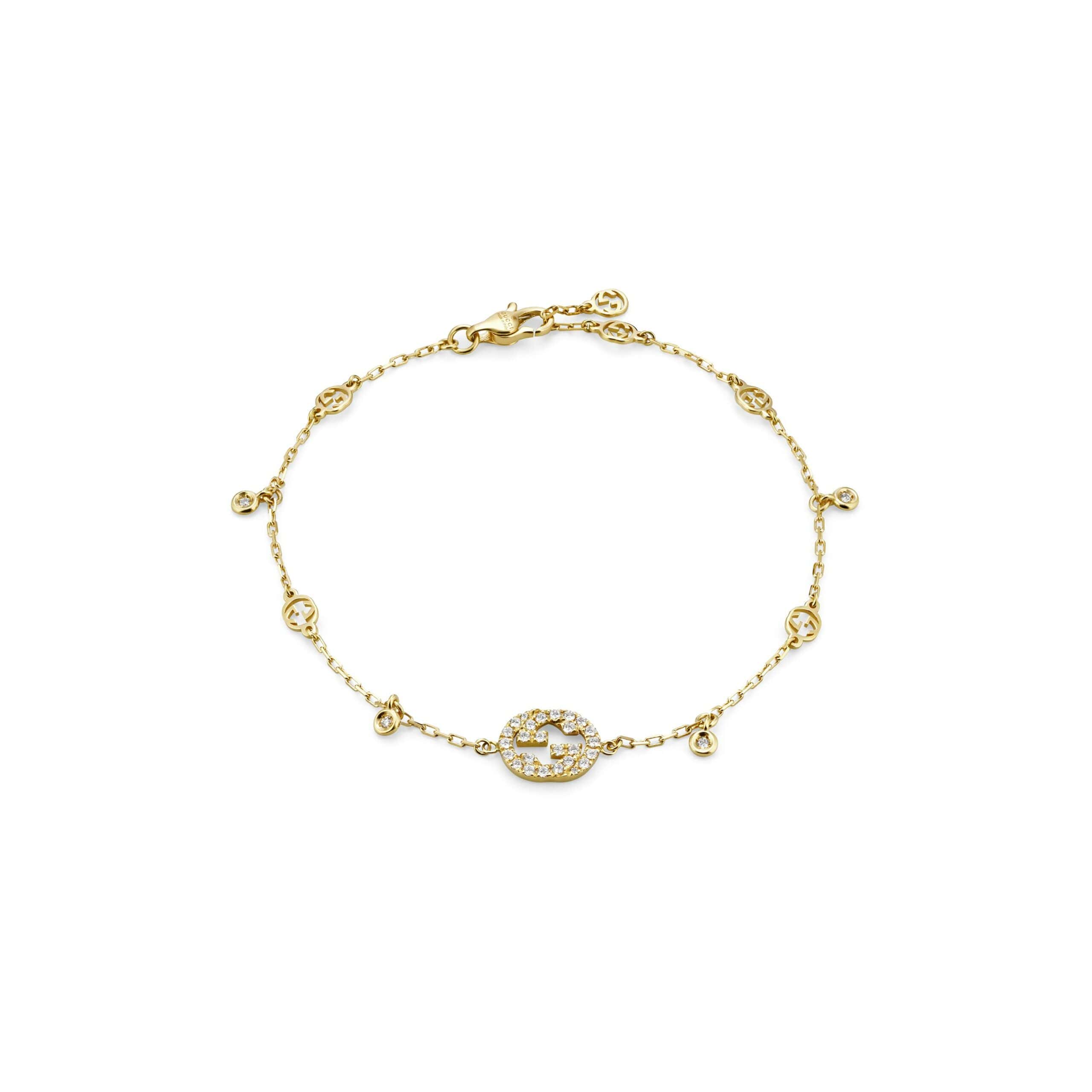 Interlocking Armschmuck von Gucci aus 18 Karat Gelbgold mit Diamanten