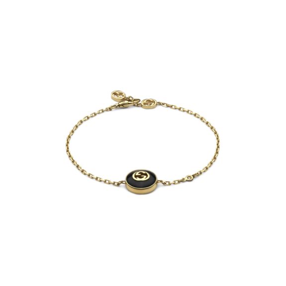 Interlocking Armschmuck von Gucci aus 18 Karat Gelbgold mit Onyx und Diamant