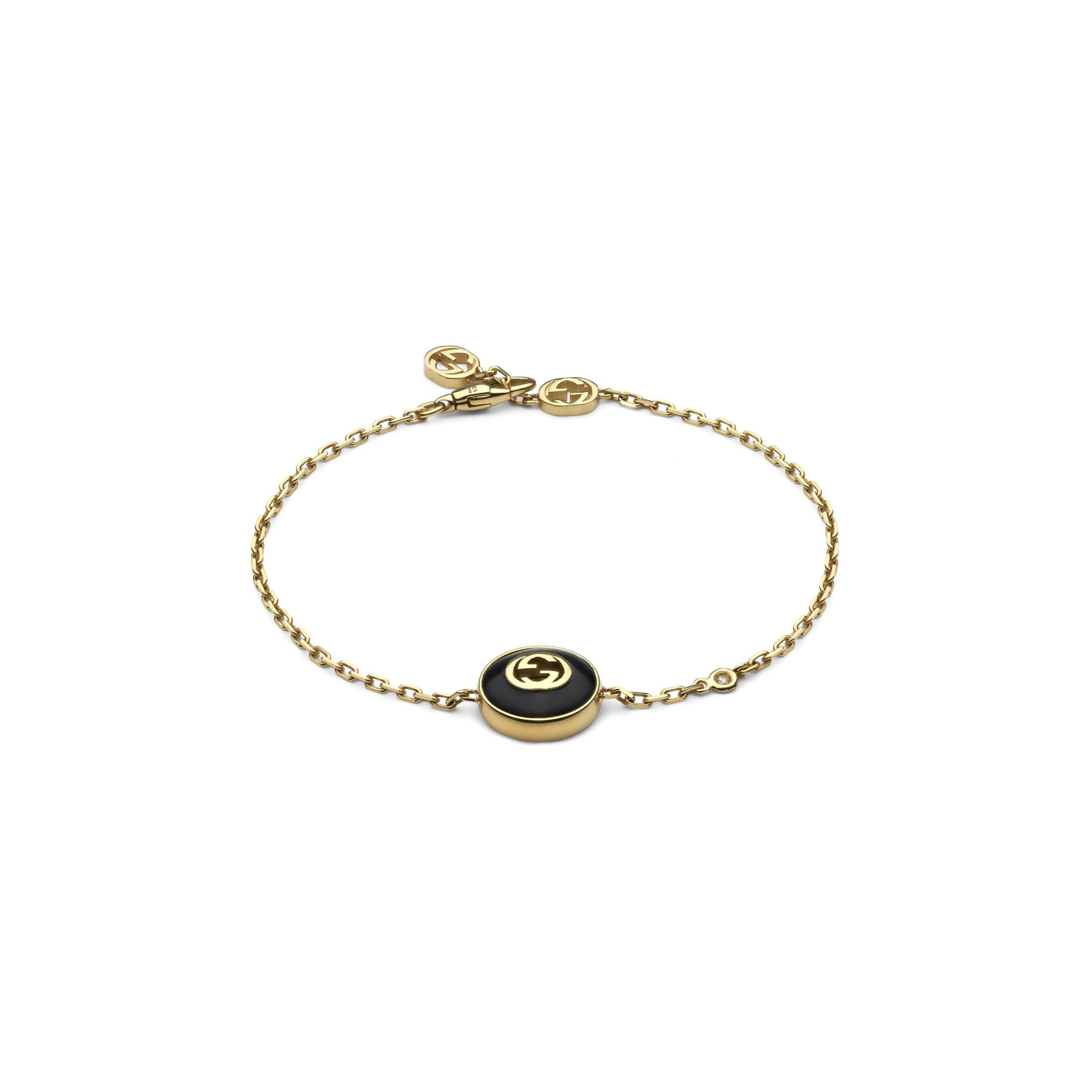 Interlocking Armschmuck von Gucci aus 18 Karat Gelbgold mit Onyx und Diamant