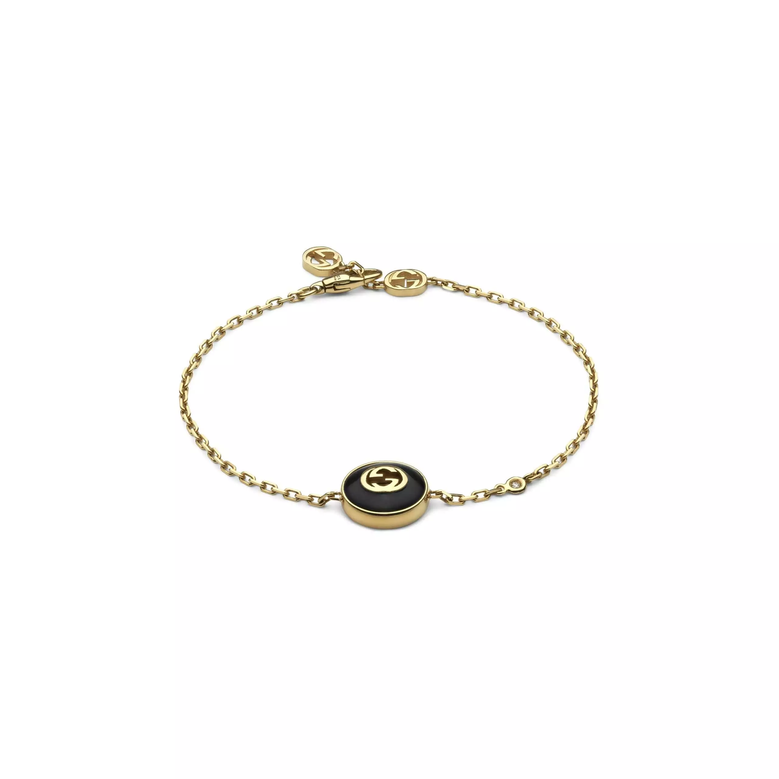 Interlocking Armschmuck von Gucci aus 18 Karat Gelbgold mit Onyx und Diamant